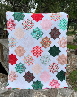 Woollypetals Floored quilt with colorful star blocks on white background