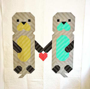 Woollypetals Don't Let Go quilt with two figures holding a red heart