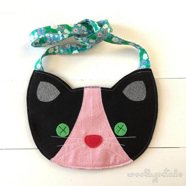 Woollypetals Felt Cat Purse with black face, pink nose, and green floral strap