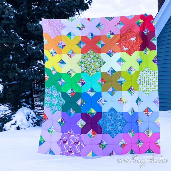 Woollypetals Floored quilt with colorful star and diamond blocks in snow
