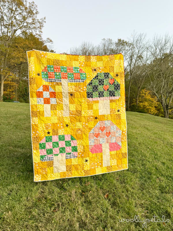 Woollypetals Capped quilt with yellow patchwork and appliqué animal blocks