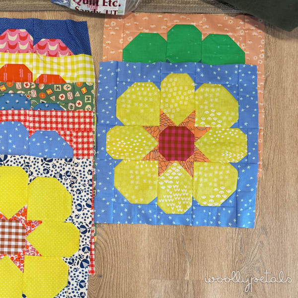 Woollypetals StarPetals Mini Quilt with yellow flower and green leaves on blue background