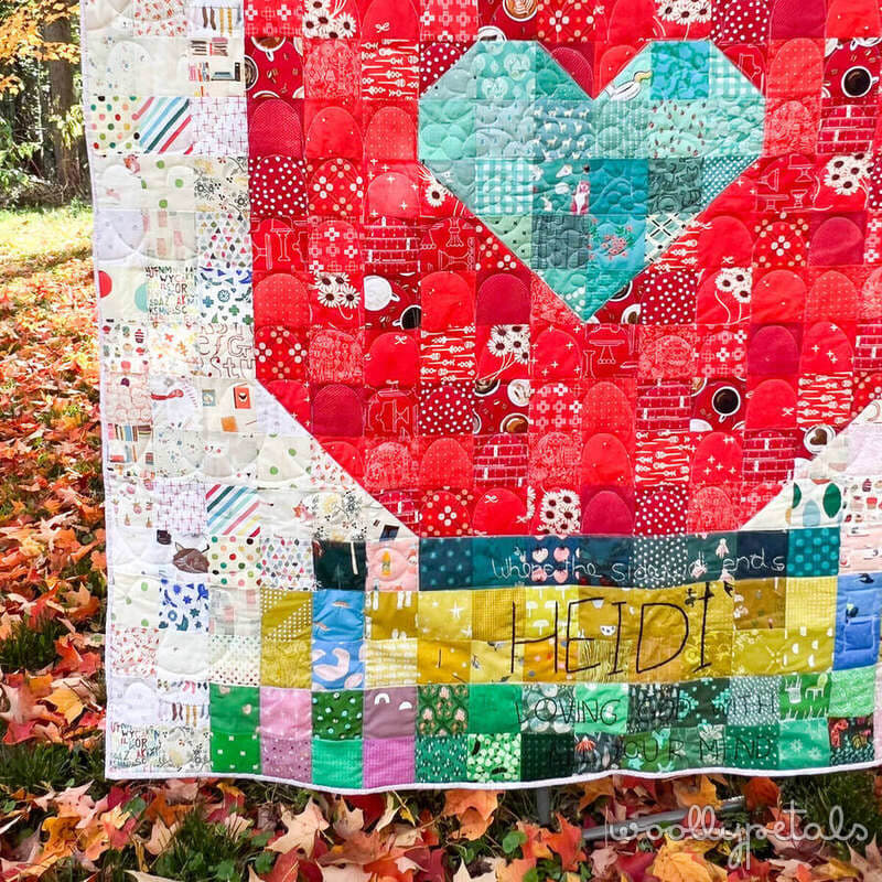 Woollypetals Book Date Patchwork Quilt with turquoise heart and colorful fabric blocks