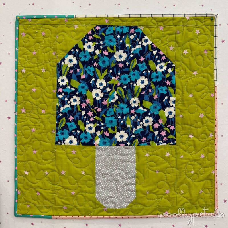 Camp Mushroom Free Block quilt with floral mushroom cap and green background