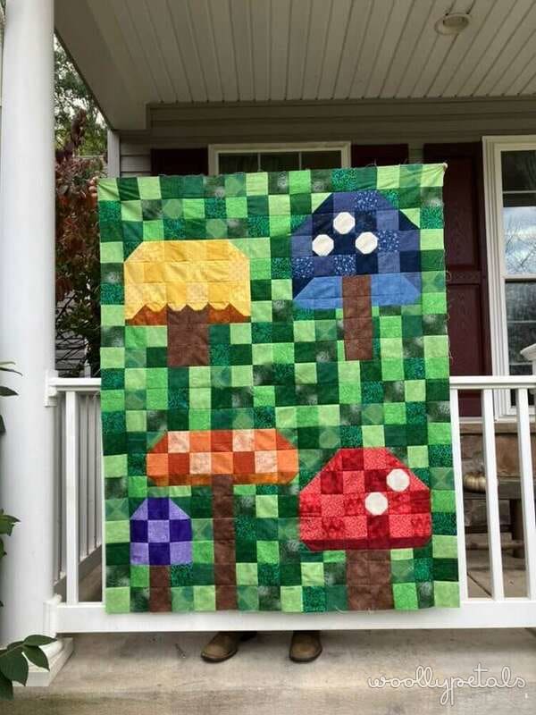 Woollypetals Capped quilt with patchwork mushrooms on green checkerboard background