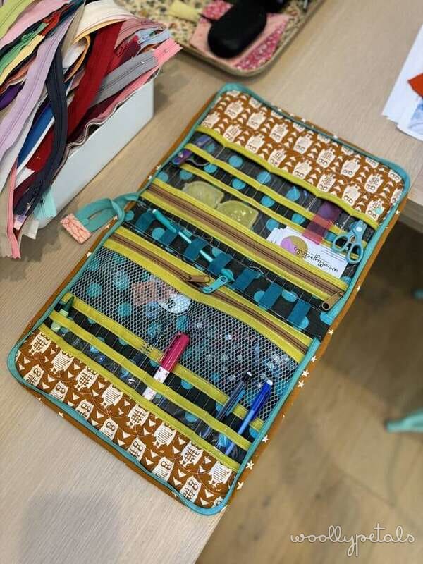 Open fabric organizer with multiple zippered pouches and storage compartments