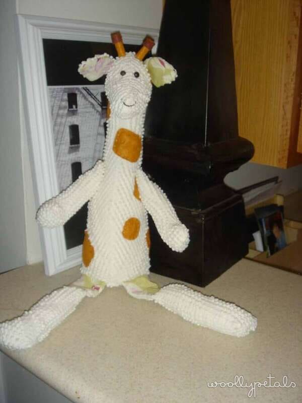Crocheted giraffe amigurumi with white body and golden spots