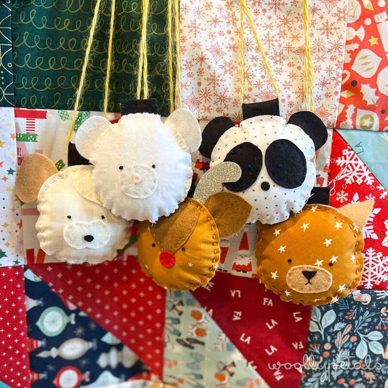 Handmade fabric animal ornaments in cream, black, and gold tones