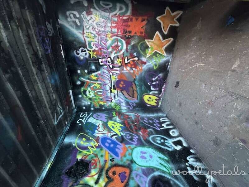 Graffiti art class project with colorful spray paint designs and gold stars