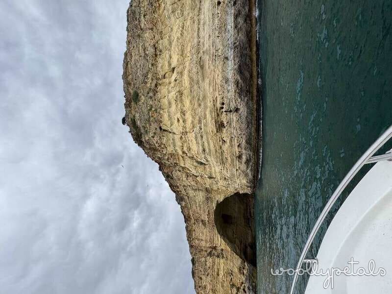 Coastal cliff and boat in Algarve, Portugal