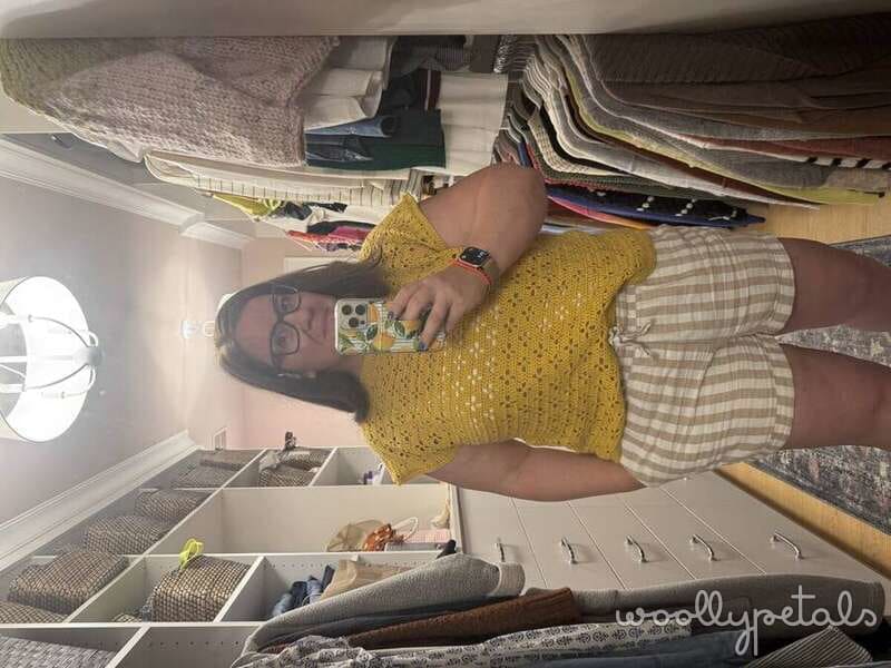 Kristin in yellow knit top organizing fabric in storage cubbies