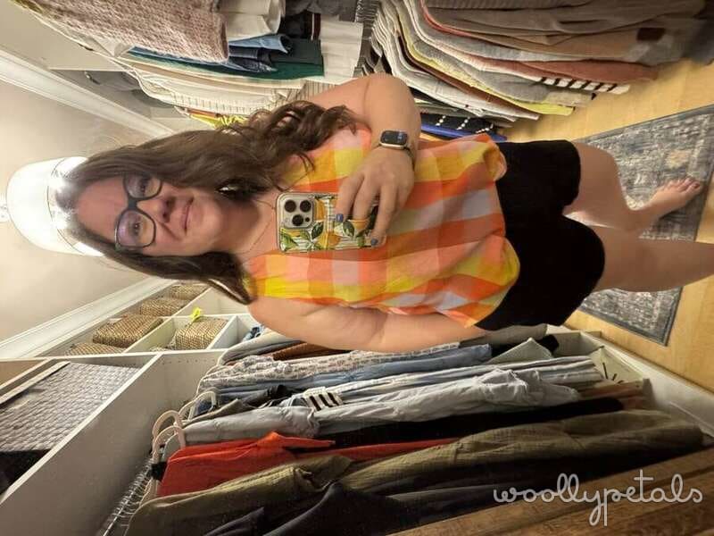 Woman holding FPP Sardine Tin sewing pattern with fabric stash