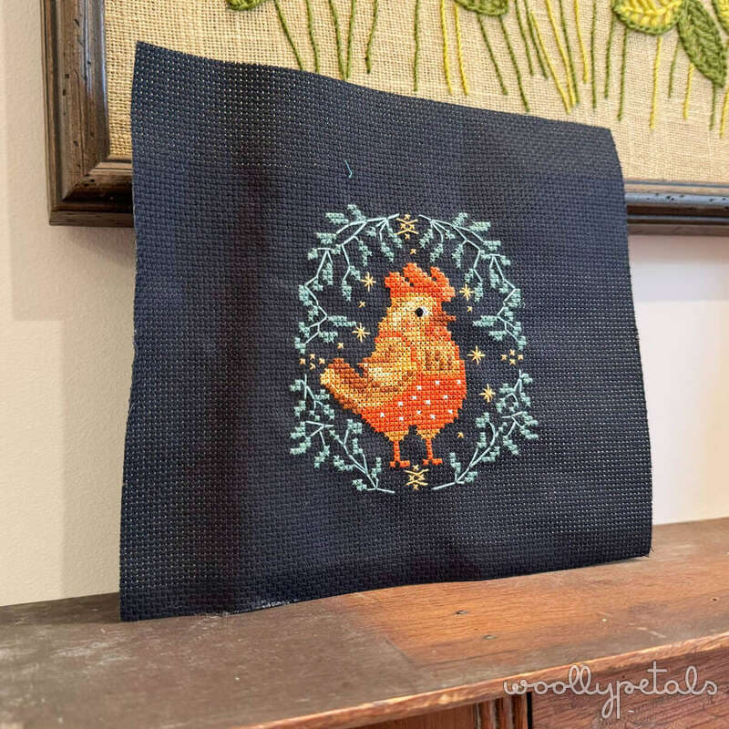 Not-So-Spooky cross stitch mini quilt with orange rooster on dark fabric
