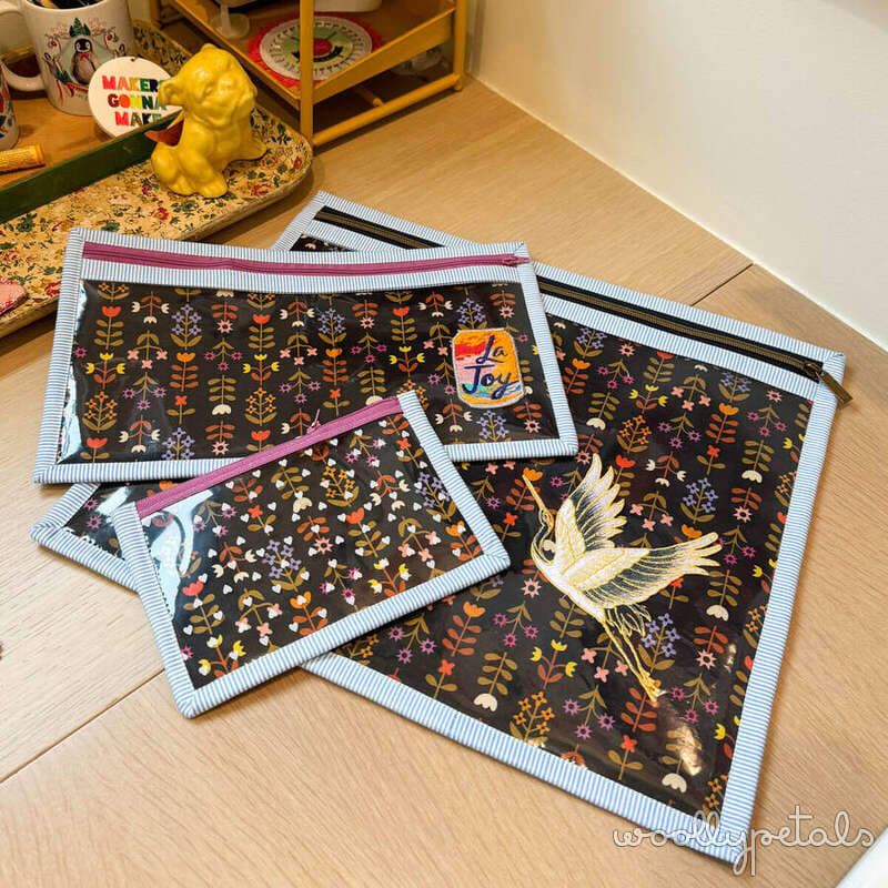 Fabric pouches with botanical pattern and coordinating ribbon closures on wooden floor
