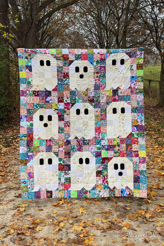 Woollypetals Ghost Party quilt with colorful patchwork and cream ghost blocks