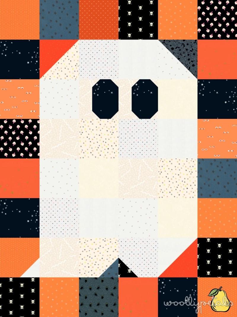 Woollypetals Ghost Party quilt with white ghost shape and colorful patchwork border