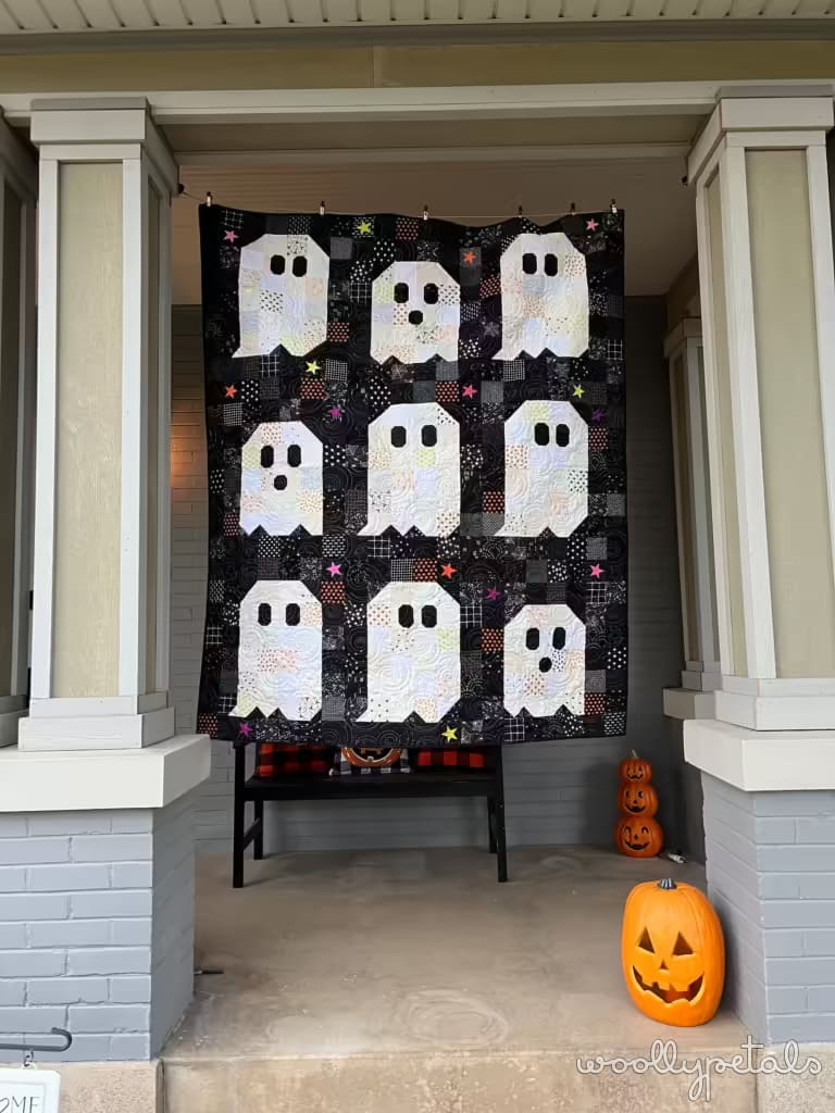Ghost Party quilt displayed on porch with Halloween decorations