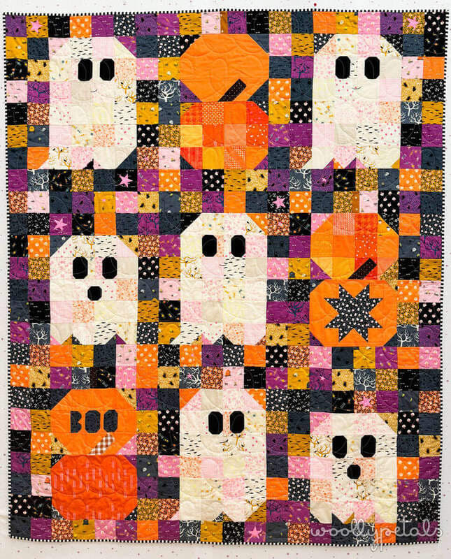 Woollypetals Ghost Party Pumpkins quilt with cream ghosts and orange pumpkins on colorful patchwork background