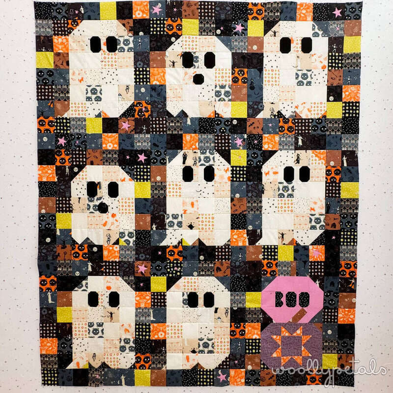 Woollypetals Ghost Party quilt top with cream ghosts and colorful patchwork blocks
