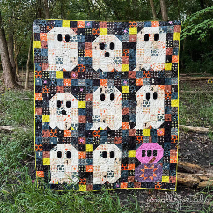 Woollypetals Ghost Party quilt with white ghost appliqués on colorful patchwork backing