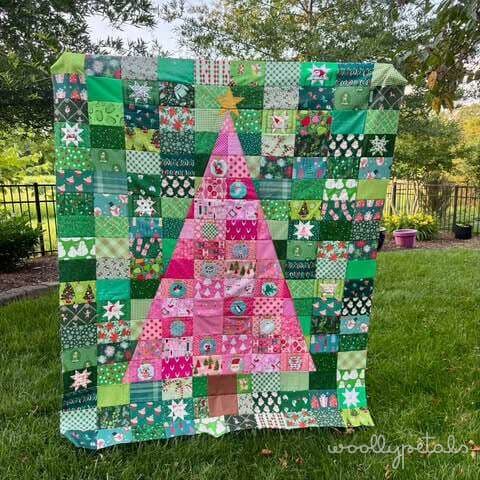 Woollypetals Oh Christmas Tree quilt with pink tree and green patchwork blocks