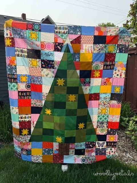 Woollypetals Oh Christmas Tree quilt with colorful patchwork and green tree design