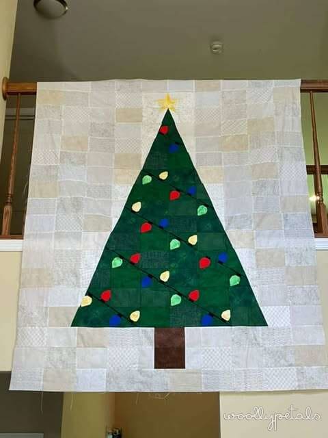 Woollypetals Oh Christmas Tree quilt with green tree, colorful ornaments, and gold star