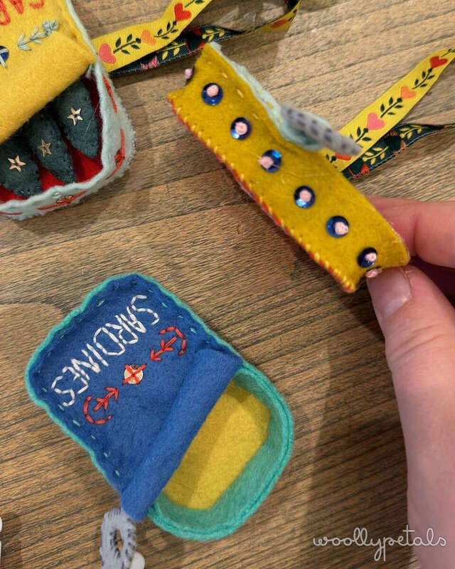 Woollypetals Sardine Tin Ornament in yellow felt with blue sequins and removable sardines