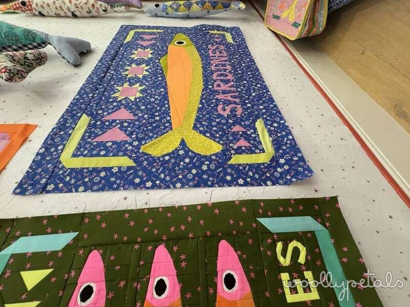 Woollypetals Sardine Tin pattern blocks in blue and green fabrics with yellow and pink sardines
