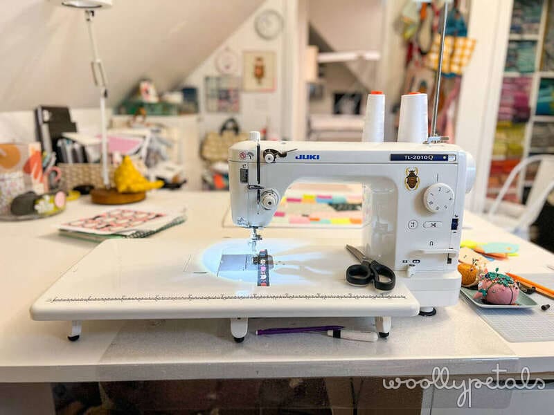 Juki sewing machine on white table in bright craft room