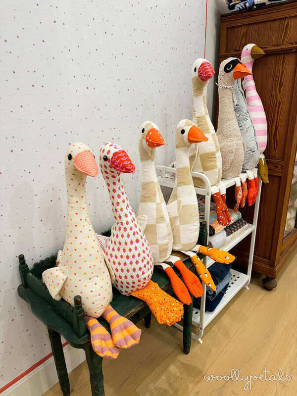 Woollypetals Silly Goose stuffed animals displayed on shelf in various fabric prints