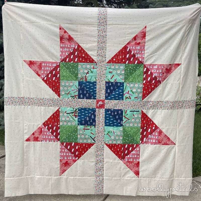 Woollypetals Starfy quilt with red sawtooth star and colorful center blocks