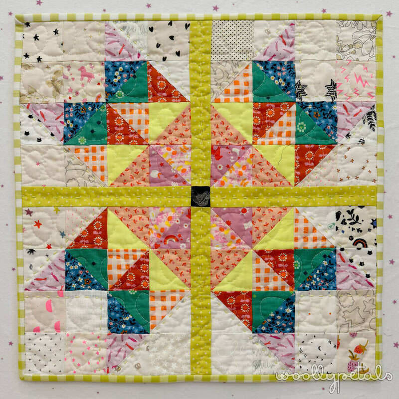 Woollypetals Starfy Quilt in colorful prismatic sawtooth star pattern