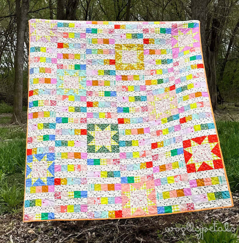 Woollypetals StarBeam quilt with colorful patchwork stars and strips