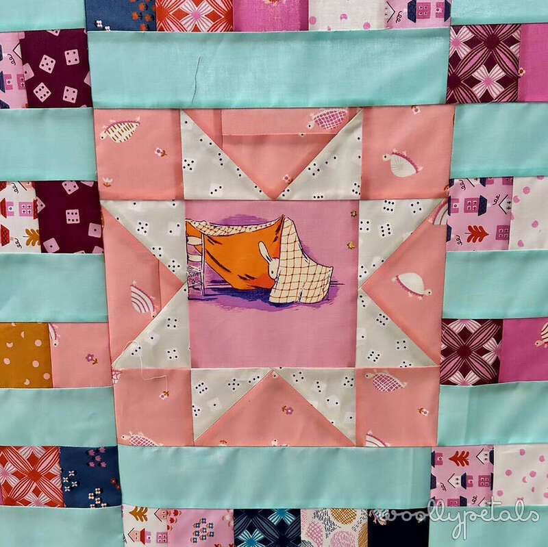 Woollypetals StarBeam quilt throw size with sawtooth star blocks in pink, cream, and mint fabrics