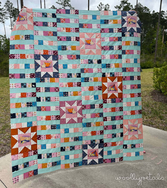 Woollypetals StarBeam quilt throw size with sawtooth stars and strip-pieced columns