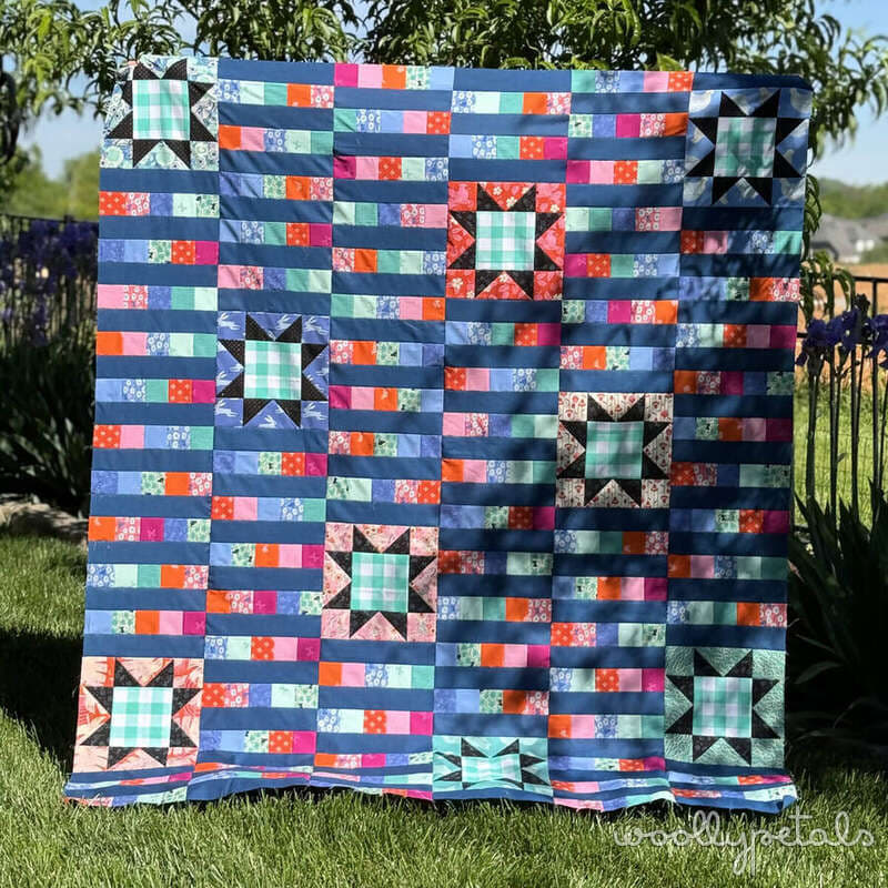 Woollypetals StarBeam quilt with sawtooth stars and strip-pieced columns in throw size