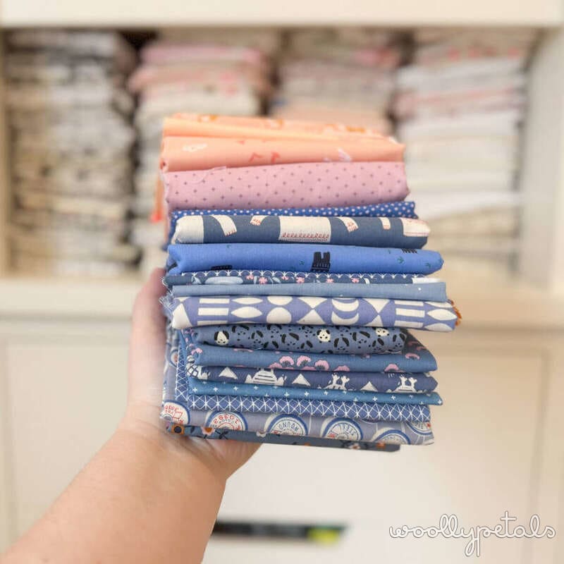 Woollypetals New Star Beginner Quilt Course fabric stack in blue, pink, and coral prints