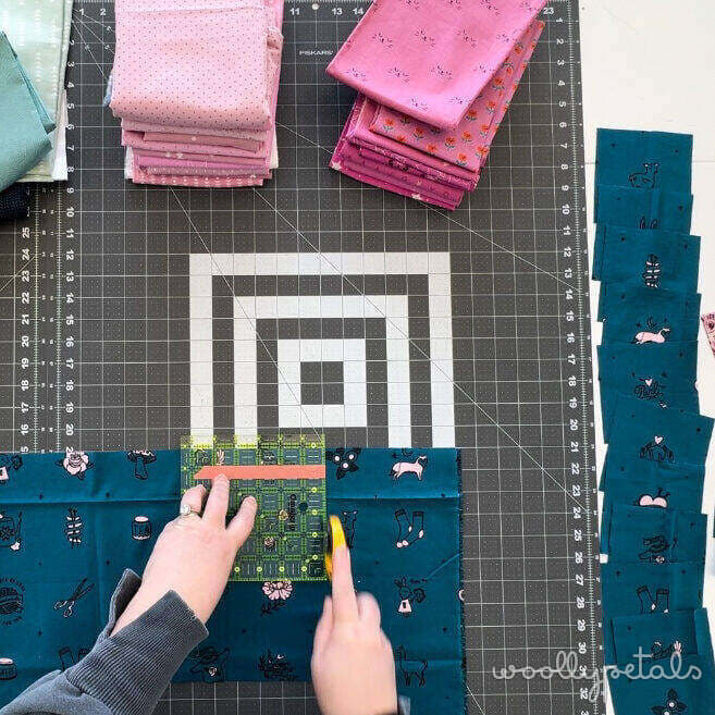 Woollypetals New Star Beginner Quilt Course Week 2 cutting fabric on a cutting mat with ruler