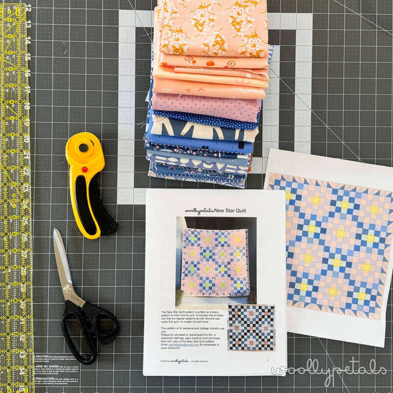 Woollypetals New Star Beginner Quilt Course Week 2 cutting setup with fabric stack, rotary cutter, scissors, and pattern instructions