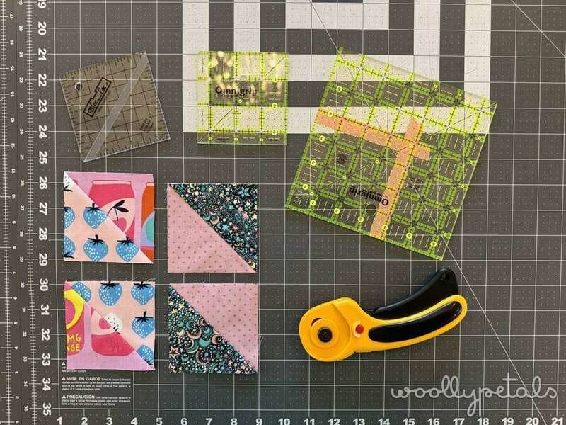 Woollypetals New Star Beginner Quilt Course fabric pieces and rotary cutter on cutting mat