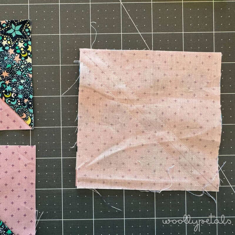 Woollypetals New Star quilt Stitch'N'Flip technique step showing diagonal seam on pink fabric square