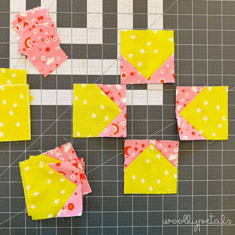 Woollypetals New Star quilt blocks with yellow and pink fabrics on cutting mat