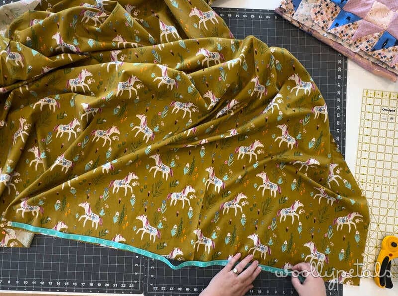 Woollypetals New Star quilt backing fabric with deer print being measured on cutting mat