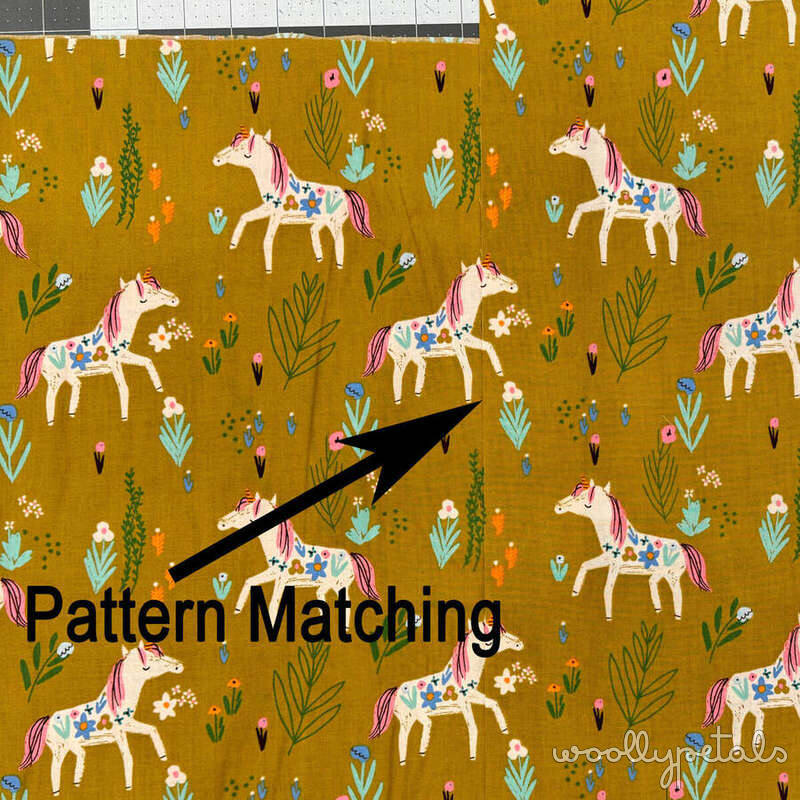 Pattern Matching fabric with unicorns, flowers, and plants on golden yellow background