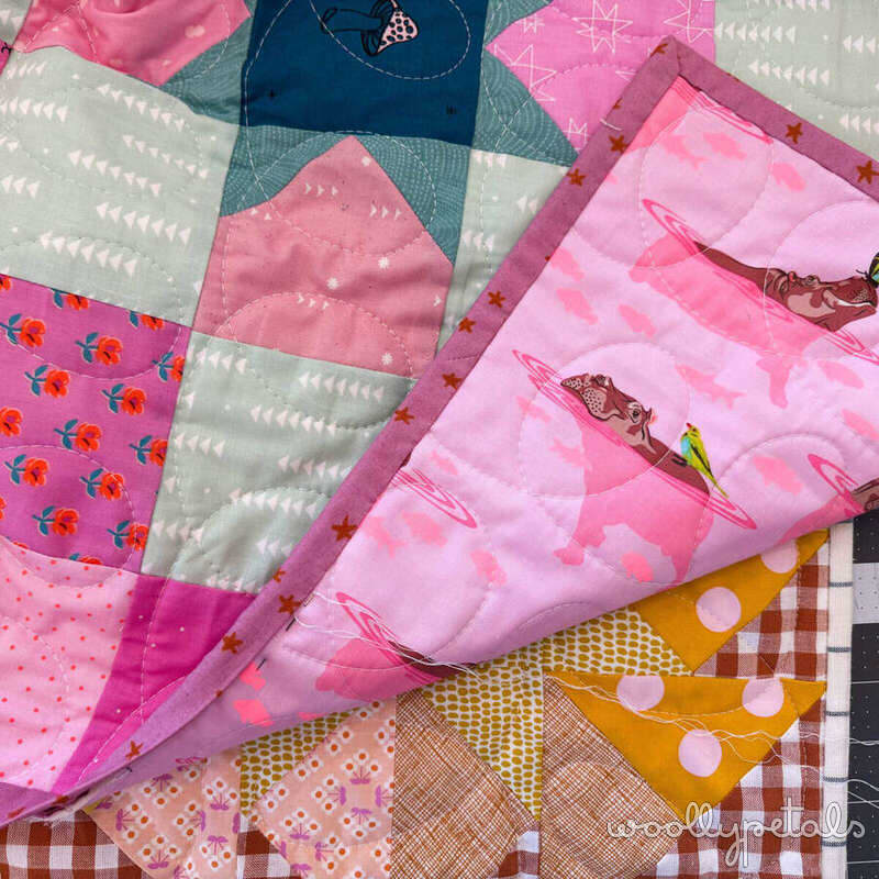 Woollypetals New Star Beginner Quilt Course binding tutorial showing colorful fabric strips and quilted pieces