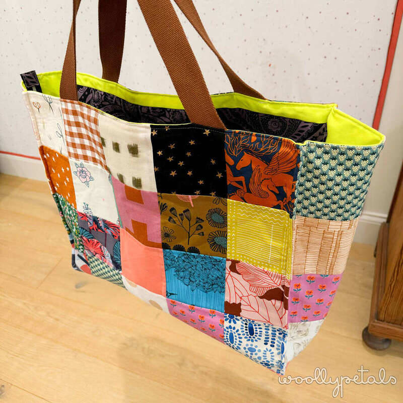 Colorful patchwork tote bag with brown handles and neon yellow lining