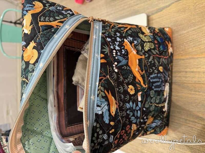 Floral patterned fabric cosmetic bag or toiletry pouch open to show interior