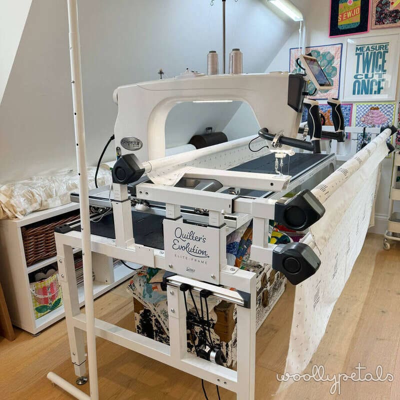Quilter's Evolution long arm quilting machine in white sewing room