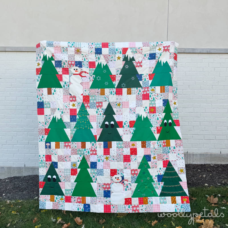 Woollypetals Enchanted Forest Quilt with green trees and patchwork blocks